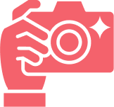 Pink icon of a hand holding a camera with a sparkle effect.